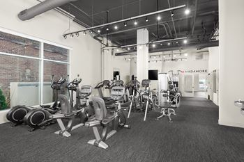 A gym with a variety of exercise equipment.